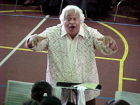 HC Pulefaasisina Palauni “Brownie” Tuiasosopo conducting ASCC’s choir