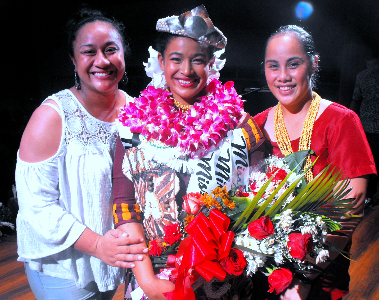 celebrates with her cousin So’onafai Lagai-Seloti (left) and Ashley Felise of ASCC Student Services